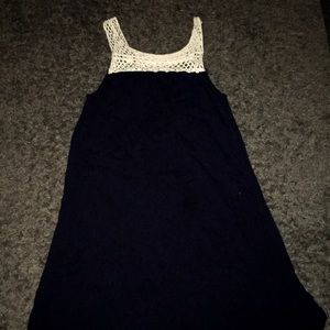 A dark blue-ish dress with no sleeves.